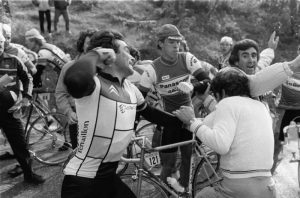 Bernard Hinault give a protester a gentle love tap